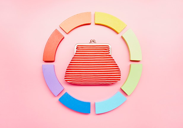 Pie chart made of colorful building blocks and wallet on pink background/