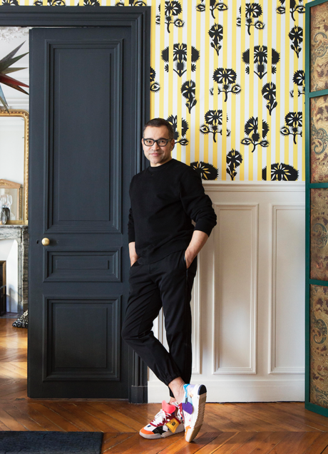 El director creativo posa ante un papel pintado diseñado por él mismo para Maison Christian Lacroix. Foto: GILLES TRILLARD