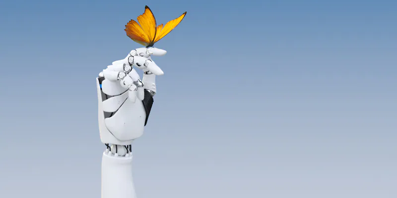 A yellow butterfly poised on a robot finger/