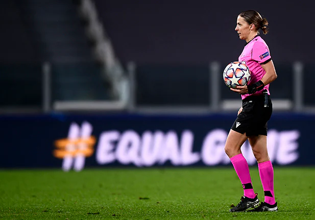 ALLIANZ STADIUM, TURIN, ITALY - 2020/12/02: Referee Stephanie Frappart holds the ball in front of a billboard reading 'equal game' at the end of the UEFA Champions League Group G football match between Juventus FC and FC Dynamo Kyiv. French referee Stephanie Frappart becomes the first-ever female official to referee a men's Champions League game. Juventus FC won 3-0 over Dynamo Kyiv. (Photo by Nicolò Campo/LightRocket via Getty Images)/