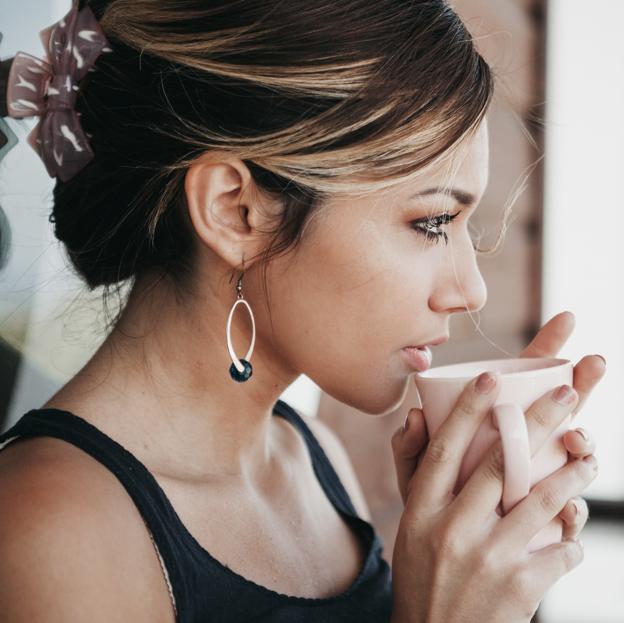 Mujer tomando una taza de infusión. 