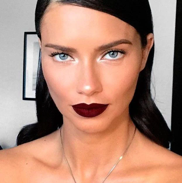 Adriana Lima con labios oscuros en maquillaje minimalista